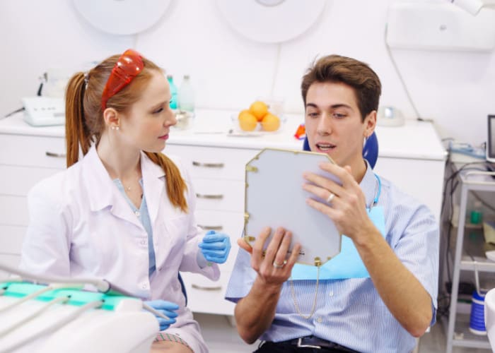 Dentist showing patient their teeth